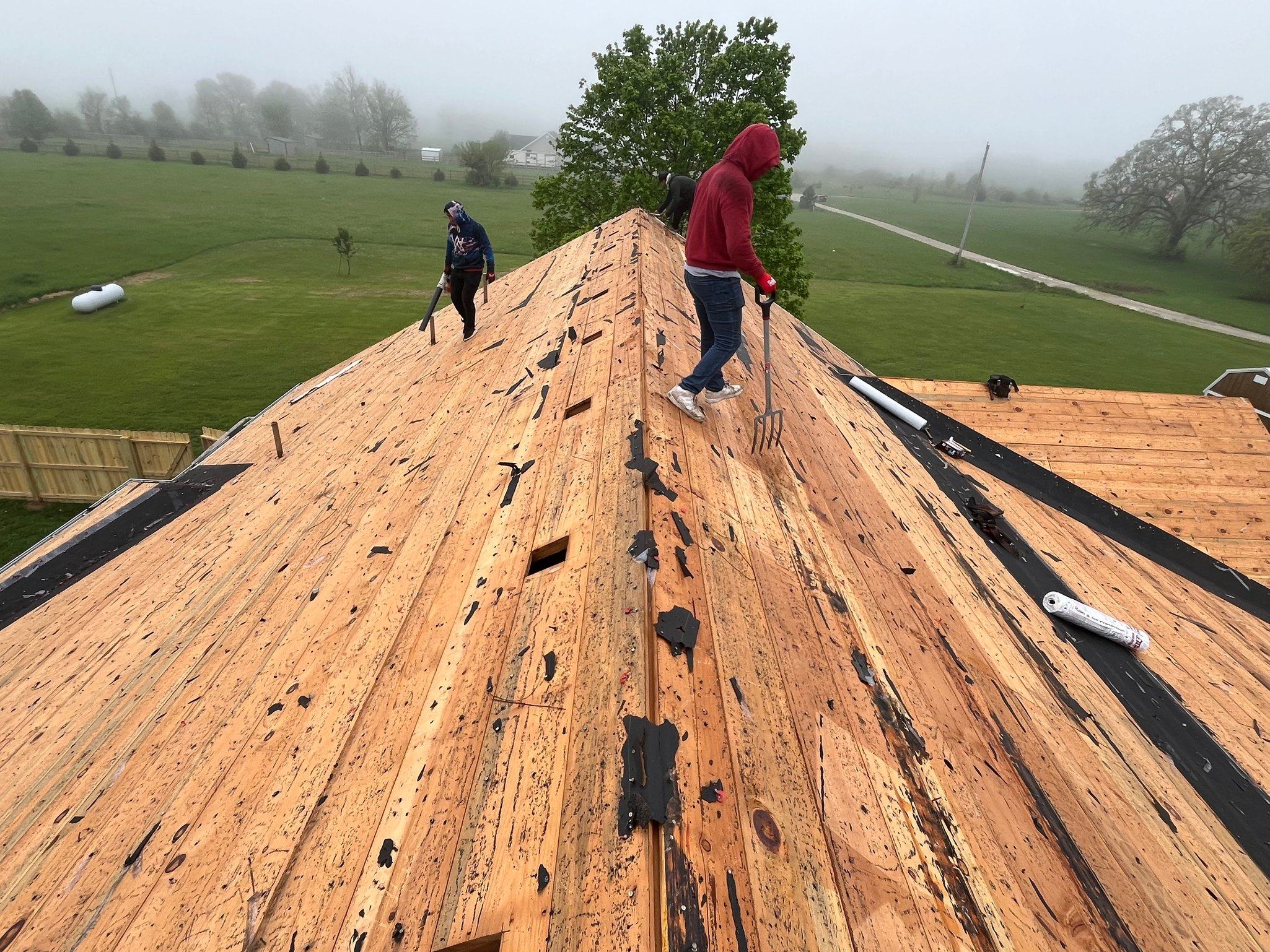 A finished asphalt shingle roof on a two-storey home