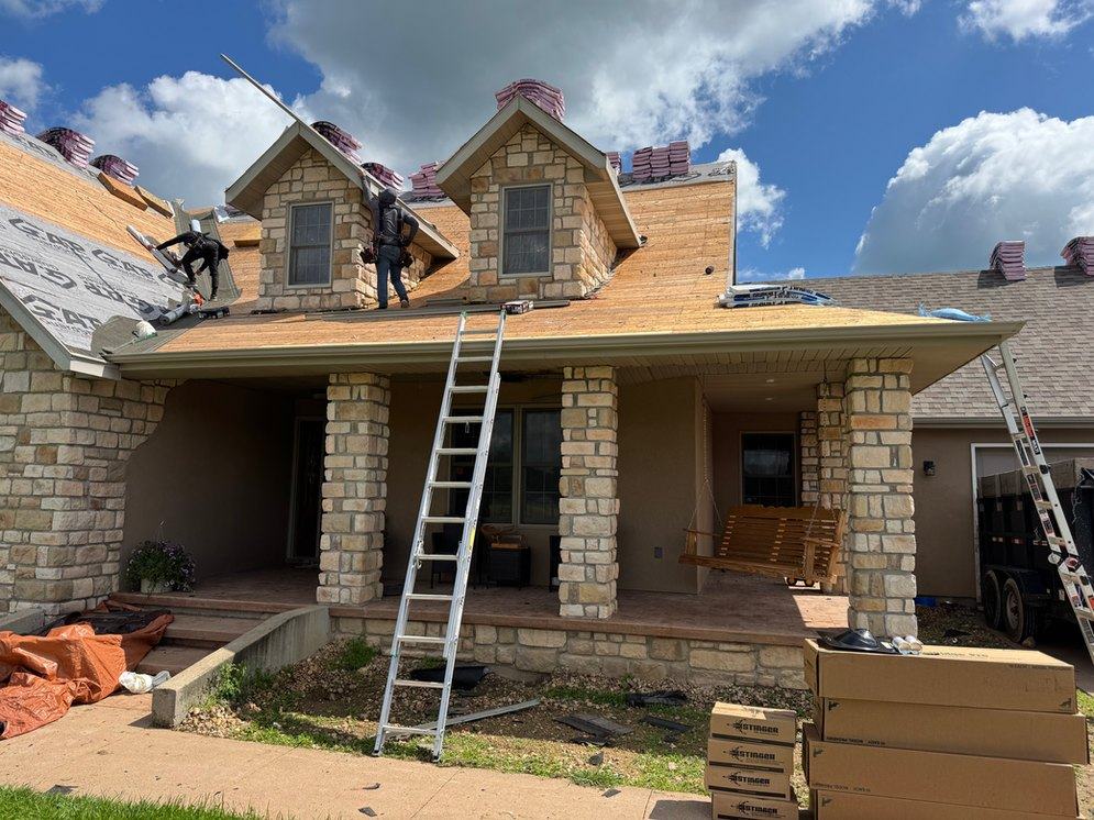 A GreenBros crew working a tear-off