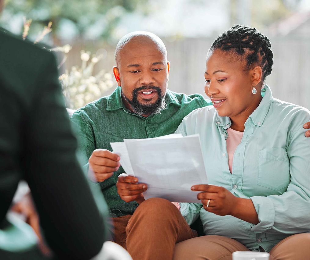 An adjuster and homeowner going through claim paperwork